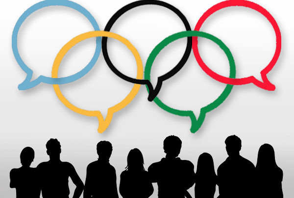 Descrição de imagem: O símbolo dos Jogos Olímpicos, composto por cinco arcos entrelaçados, com as cores azul, amarelo, preto, verde e vermelho sobre um fundo branco aparecem como balões de diálogos e, embaixo deles, a sombra de várias pessoas, como se estivessem conversando.