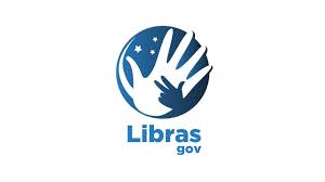 Em fundo branco com detalhes em azul, logomarca do LibrasGov é formada por duas mãos, uma grande na cor branca e uma menor, azul, dentro de uma esfera que remete à bandeira do Brasil
